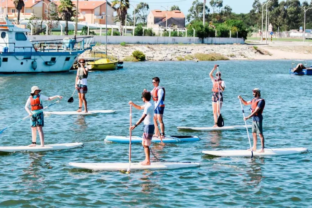 Stand Up Paddle lesson with a boat and road in the background.